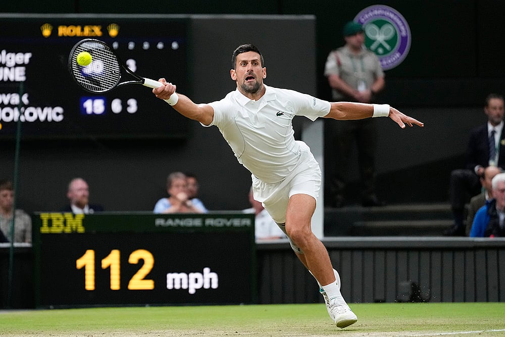 | Photo: Kirsty Wigglesworth : Novak Djokovic plays a forehand return to Holger Rune